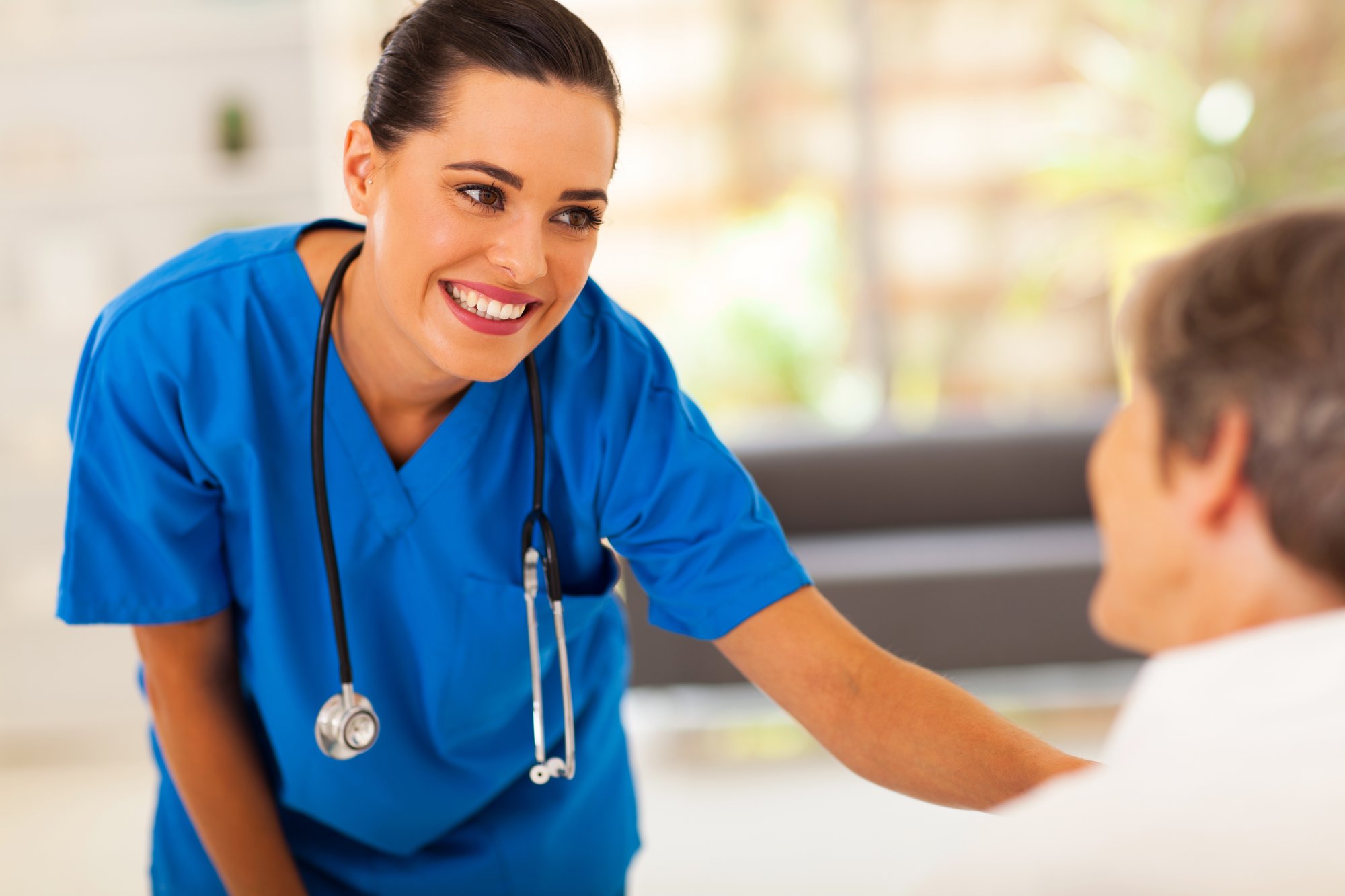 young nurse talking to senior patient in hospital_126153416